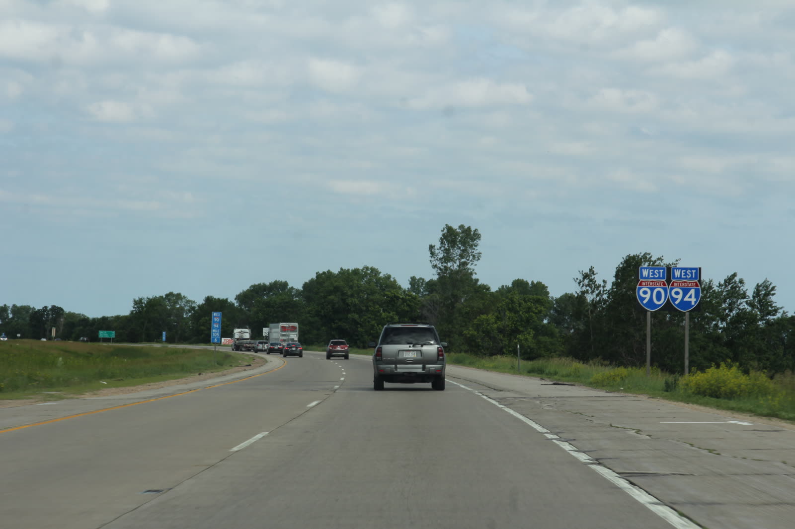 A green mile marker sign reading 150.6 at the side of an interstate highway.
